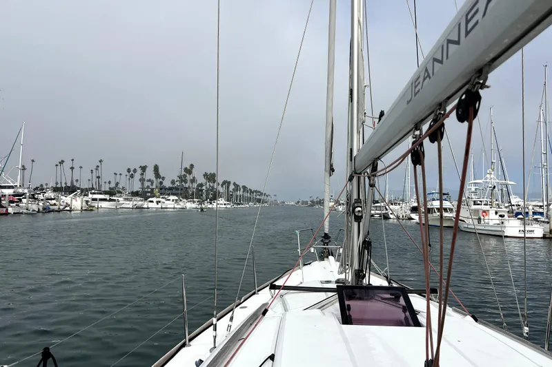 Slide: The Image of 2014 Jeanneau Sun Odyssey 379 sailboat deck with ropes and winches in marina. - 14