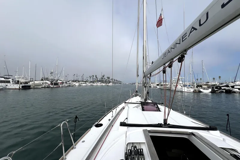 Slide: The Image of 2014 Jeanneau Sun Odyssey 379 sailboat deck with ropes and winch in marina. - 15