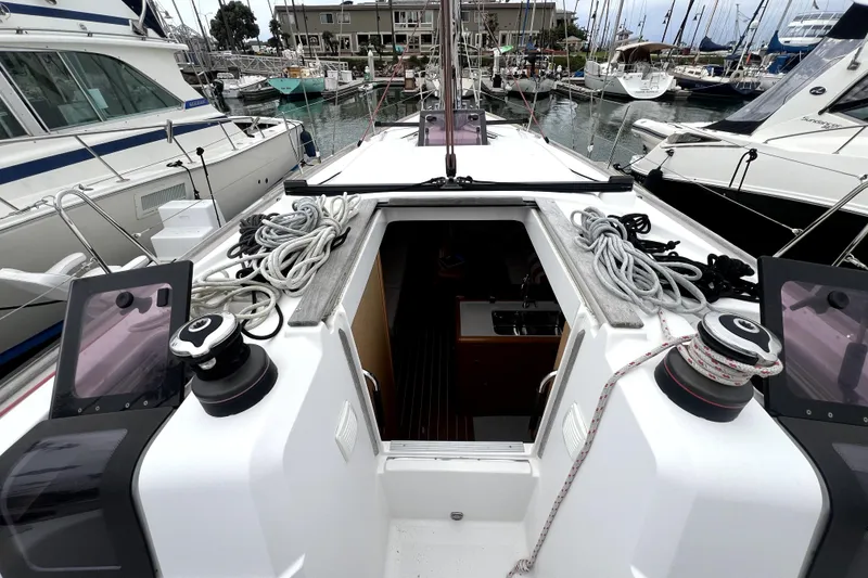 Slide: The Image of 2014 Jeanneau Sun Odyssey 379 sailboat cruising in a marina under clear blue skies. - 2