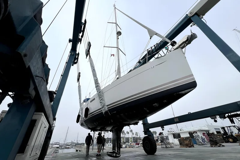 Slide: The Image of Sailboat Jeanneau Sun Odyssey 379, 2014 model, with sails unfurled in a marina. - 20