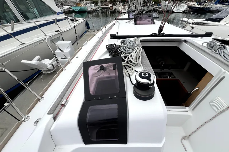Slide: The Image of 2014 Jeanneau Sun Odyssey 379 sailing in a marina with other boats docked. - 3
