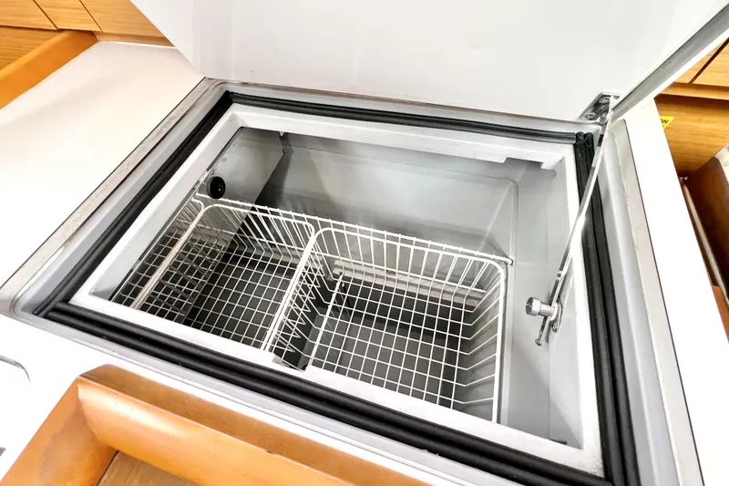 Slide: The Image of 2014 Jeanneau Sun Odyssey 379 interior with modern kitchen and cozy seating area. - 35