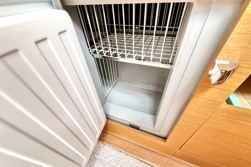 Slide: The Image of Modern kitchen interior of 2014 Jeanneau Sun Odyssey 379 yacht with wood finish and appliances. - 36