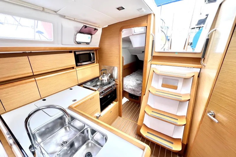 Slide: The Image of Open refrigerator compartment on 2014 Jeanneau Sun Odyssey 379 yacht, featuring wire baskets. - 38