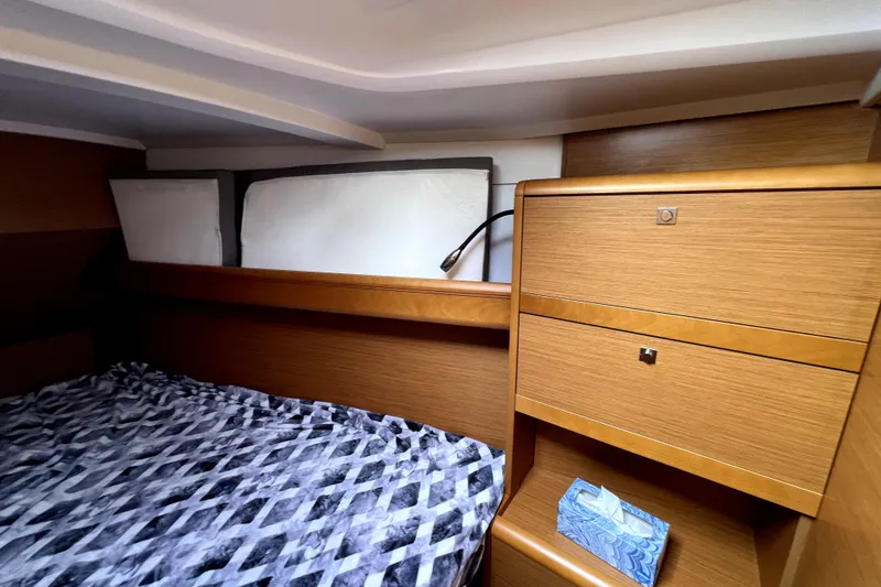 Slide: The Image of Cozy cabin interior of 2014 Jeanneau Sun Odyssey 379 sailboat with bed and pillows. - 47