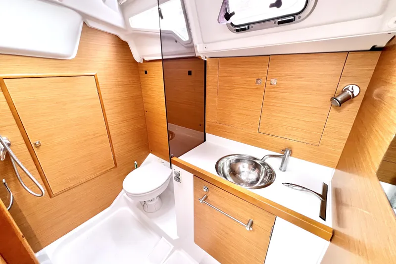 Slide: The Image of Cozy cabin interior of 2014 Jeanneau Sun Odyssey 379 sailboat with nautical-themed pillows. - 48