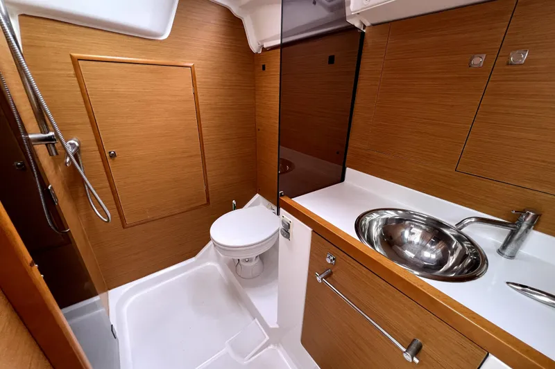 Slide: The Image of Cozy cabin interior of 2014 Jeanneau Sun Odyssey 379 sailboat with wooden finish. - 50