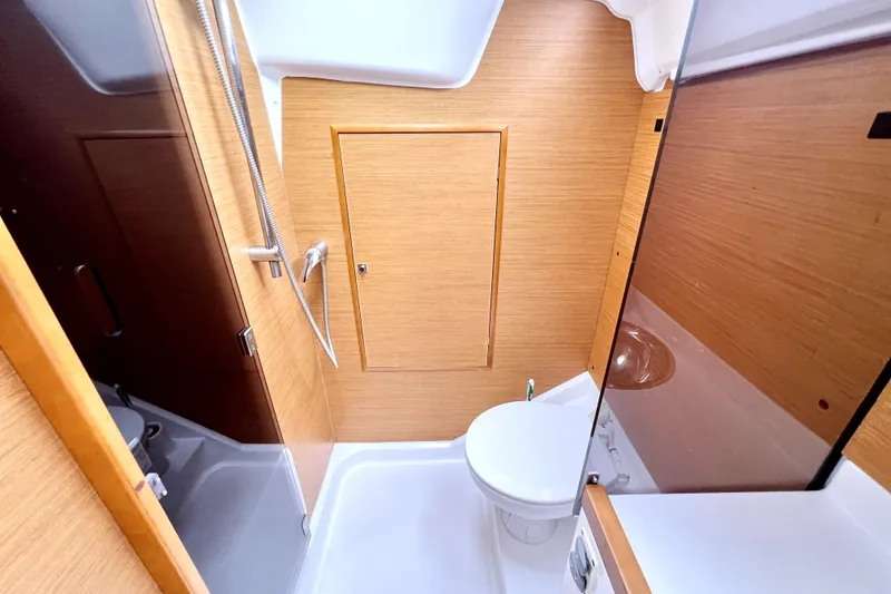 Slide: The Image of 2014 Jeanneau Sun Odyssey 379 yacht bathroom with modern fixtures and wooden cabinetry. - 51