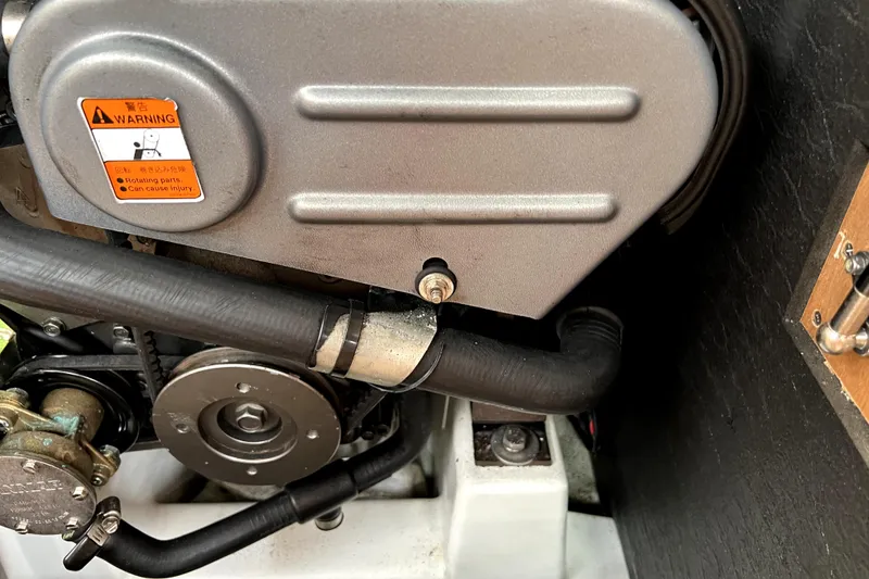 Slide: The Image of Engine compartment of 2014 Jeanneau Sun Odyssey 379 sailboat, showcasing detailed mechanical components. - 57