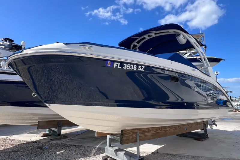 The Image of 2021 Sea Ray SDX 270 Outboard boat on display under a clear blue sky. - 0