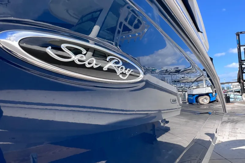 Slide: The Image of 2021 Sea Ray SDX 270 Outboard boat with sleek blue exterior and logo. - 10