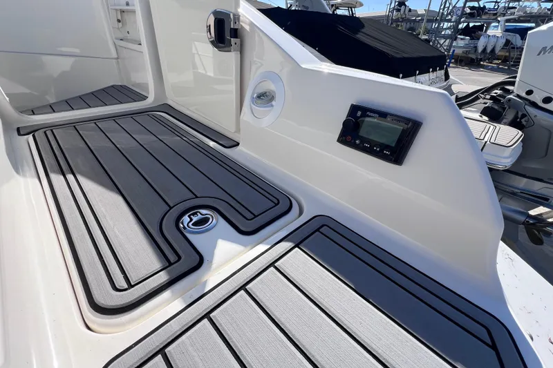 Slide: The Image of 2021 Sea Ray SDX 270 Outboard deck with sleek flooring and control panel. - 12
