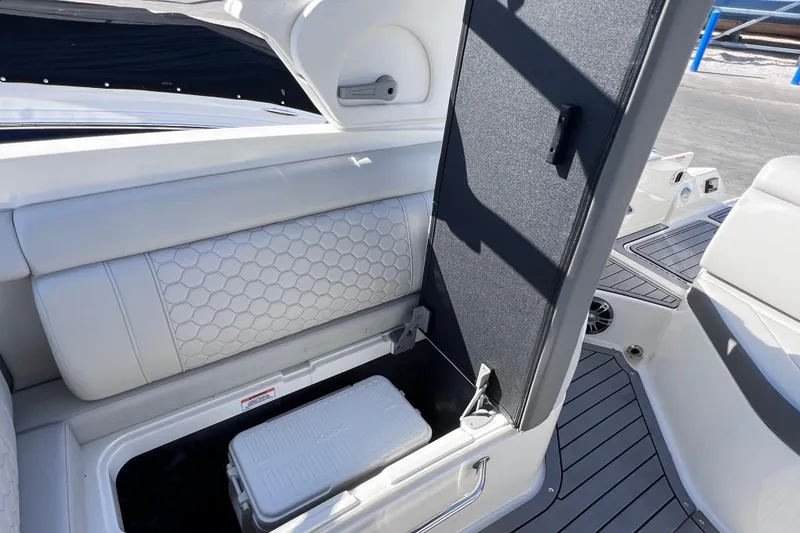 Slide: The Image of 2021 Sea Ray SDX 270 Outboard boat with open storage compartment and cooler. - 22