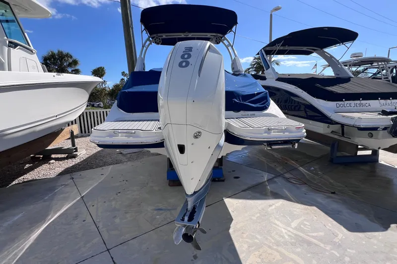 Slide: The Image of 2021 Sea Ray SDX 270 Outboard boat with powerful engine, docked under clear blue sky. - 3