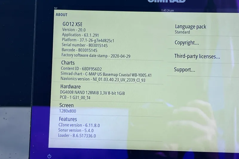 Slide: The Image of Simrad GO12 XSE display showing software and hardware details on a 2021 Sea Ray SDX 270 Outboard. - 32