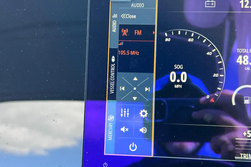 Slide: The Image of Dashboard of 2021 Sea Ray SDX 270 Outboard showing audio and speed controls. - 34