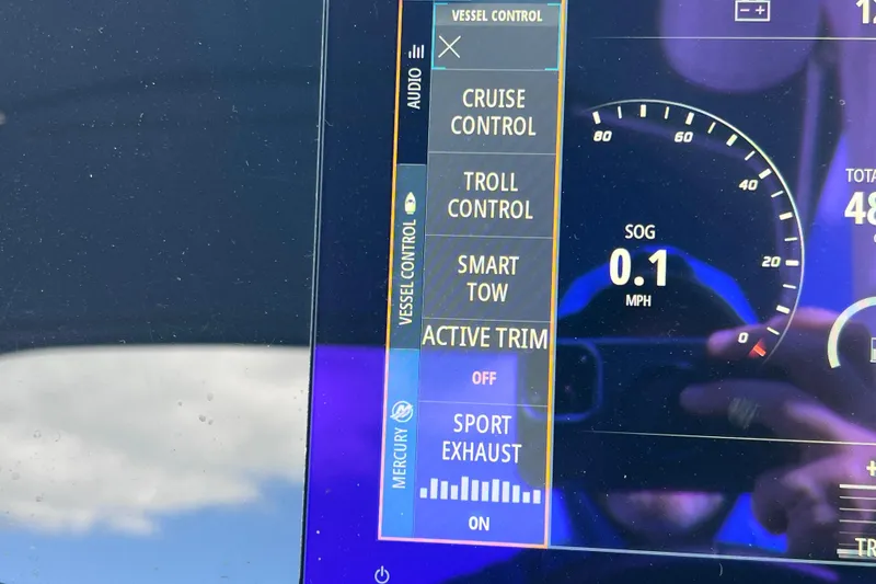 Slide: The Image of 2021 Sea Ray SDX 270 Outboard dashboard displaying vessel control options and speedometer. - 35