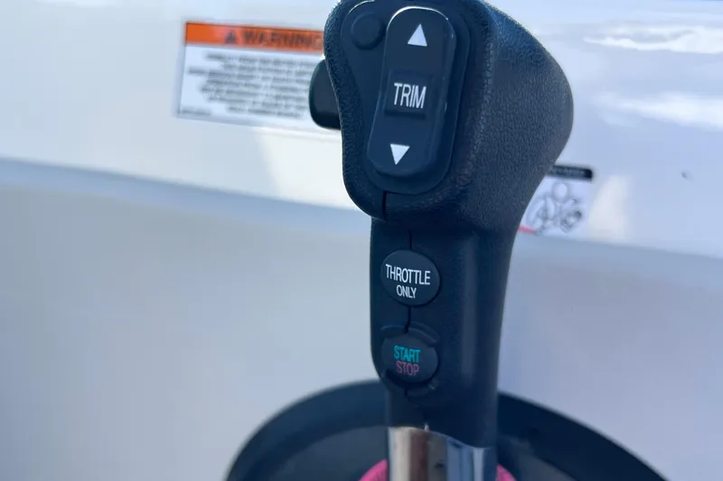Slide: The Image of Throttle control of 2021 Sea Ray SDX 270 Outboard boat, featuring trim and start/stop buttons. - 37