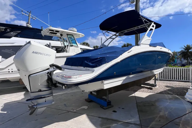 Slide: The Image of 2021 Sea Ray SDX 270 Outboard boat with Mercury engine, docked under blue sky. - 4