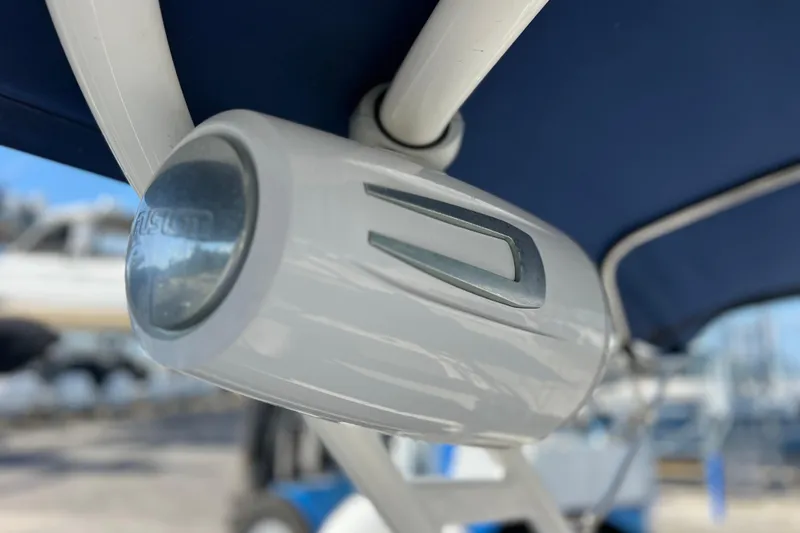Slide: The Image of Close-up of a 2021 Sea Ray SDX 270 Outboard boat speaker under a blue canopy. - 40