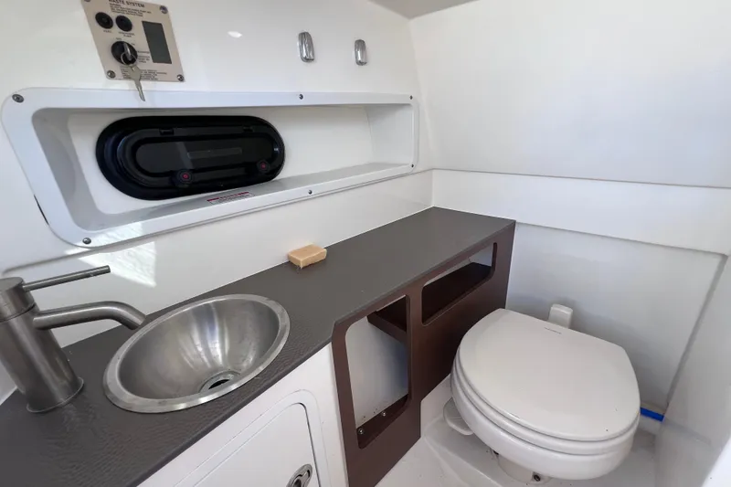 Slide: The Image of 2021 Sea Ray SDX 270 Outboard boat bathroom with sink and toilet. - 43