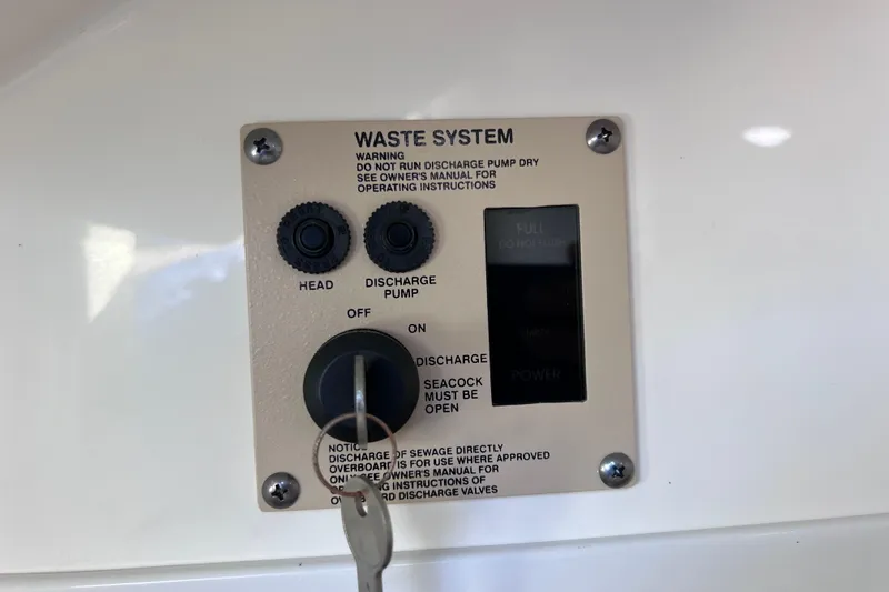 Slide: The Image of Control panel of 2021 Sea Ray SDX 270 Outboard waste system with discharge pump settings. - 44