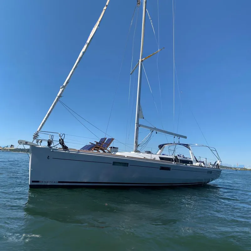 The Image of 2018 Beneteau Oceanis 45 sailboat on calm water under clear blue sky. - 0