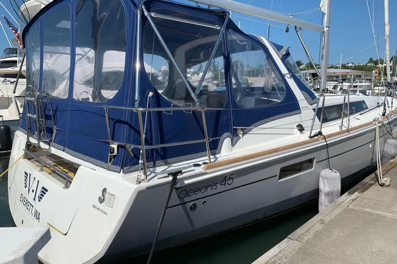 Slide: The Image of 2018 Beneteau Oceanis 45 sailboat docked with blue canopy in marina. - 11