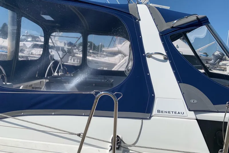 Slide: The Image of 2018 Beneteau Oceanis 45 sailboat with blue canopy, docked in marina. - 12