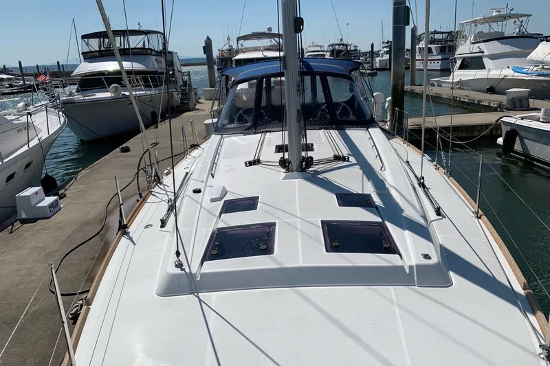 Slide: The Image of 2018 Beneteau Oceanis 45 sailboat docked at marina, surrounded by other boats. - 13