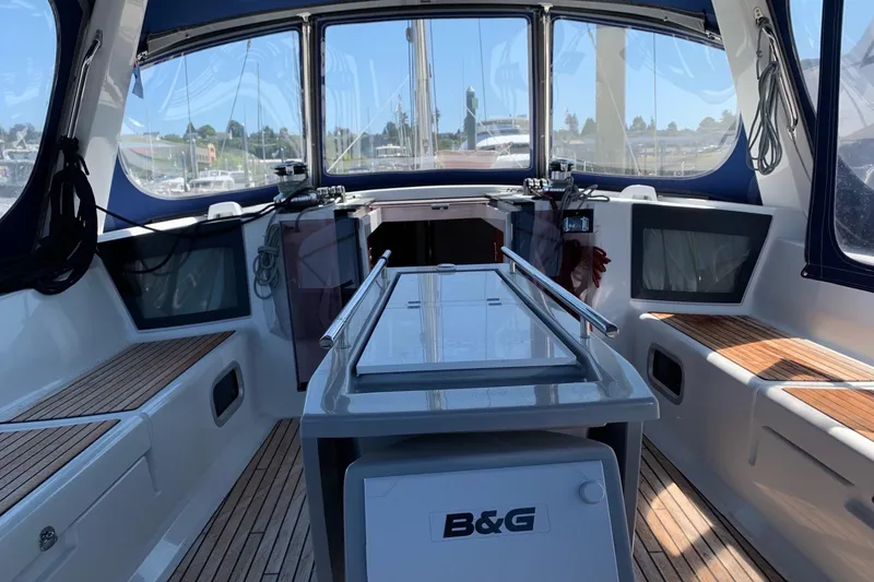 Slide: The Image of 2018 Beneteau Oceanis 45 yacht cockpit with teak seating and navigation equipment. - 15