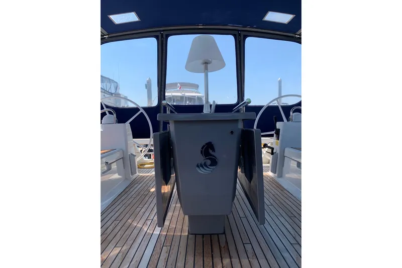 Slide: The Image of 2018 Beneteau Oceanis 45 yacht cockpit with wooden deck and steering wheels. - 16