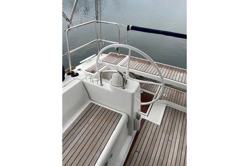 Slide: The Image of Cockpit of 2018 Beneteau Oceanis 45 sailboat with wooden deck and steering wheel. - 21