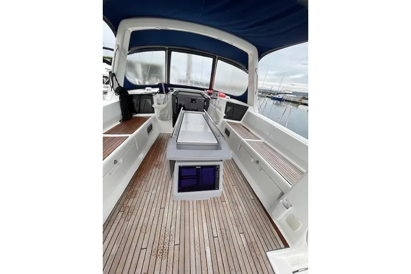 Slide: The Image of 2018 Beneteau Oceanis 45 yacht cockpit with teak flooring and blue canopy. - 27