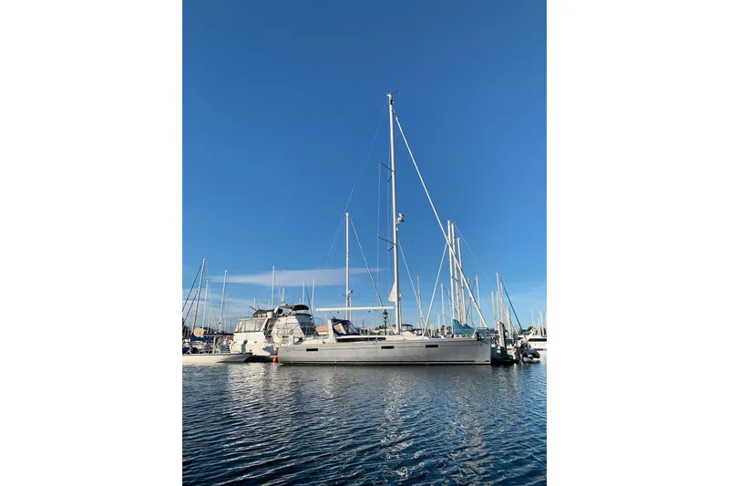 Slide: The Image of 2018 Beneteau Oceanis 45 sailboat docked in a marina under clear blue skies. - 3