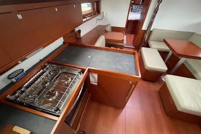 Slide: The Image of Interior of 2018 Beneteau Oceanis 45 yacht with modern kitchen and seating area. - 32