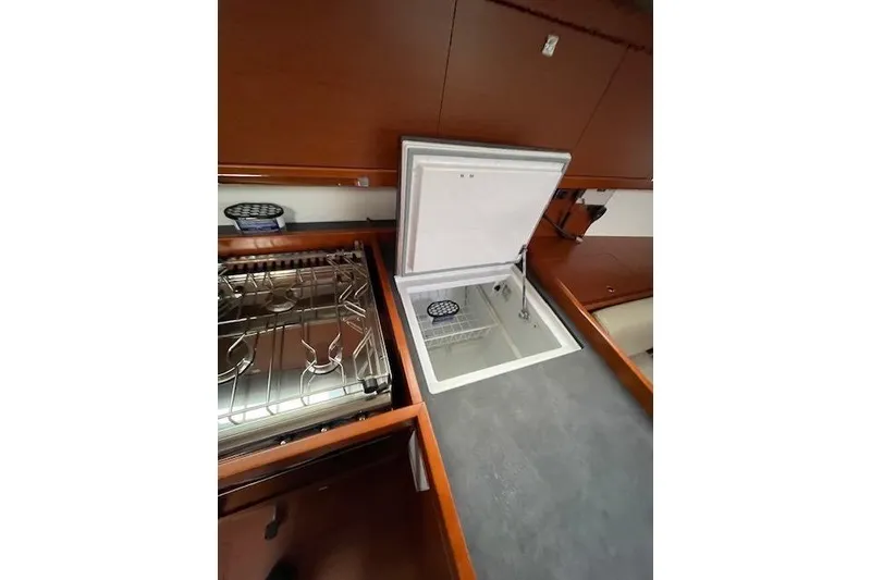 Slide: The Image of 2018 Beneteau Oceanis 45 yacht kitchen with stove and open fridge. - 34