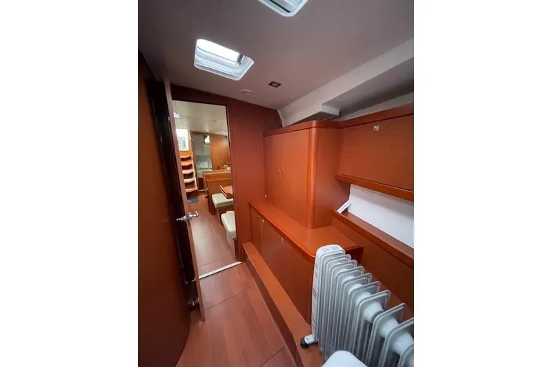 Slide: The Image of Interior of 2018 Beneteau Oceanis 45 yacht, featuring wooden cabinetry and modern design. - 43
