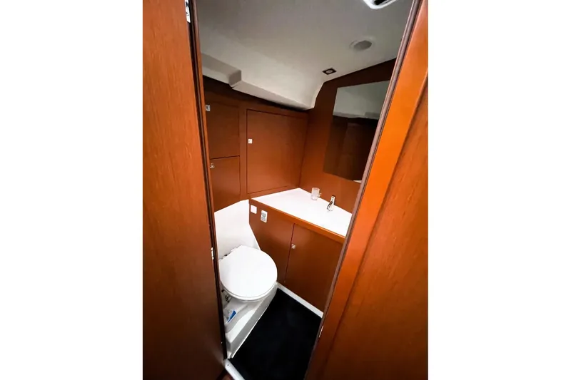 Slide: The Image of Interior of 2018 Beneteau Oceanis 45 yacht bathroom with wooden cabinetry and modern fixtures. - 49