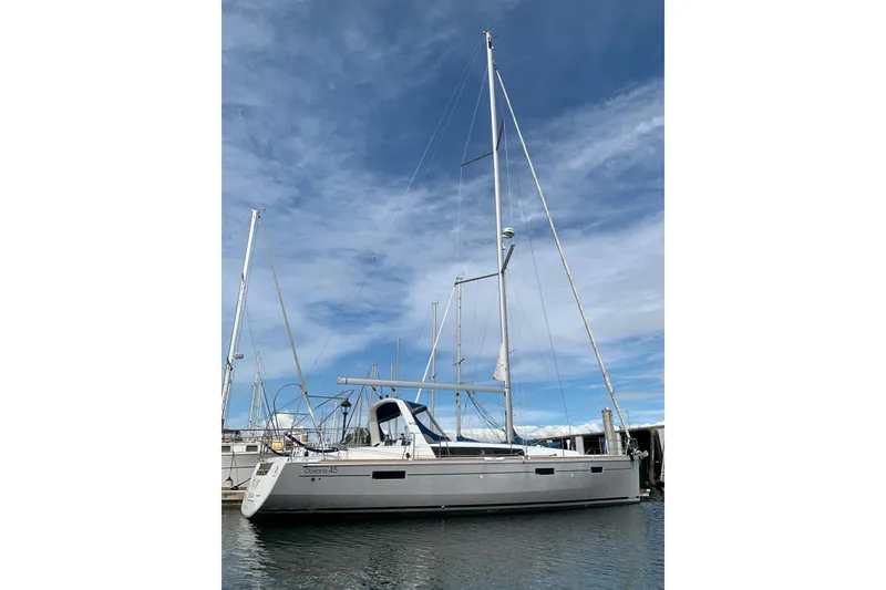 Slide: The Image of 2018 Beneteau Oceanis 45 sailboat docked under a clear blue sky. - 8