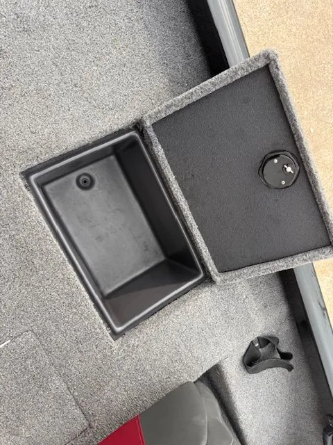 Slide: The Image of Ranger RT178 2023 boat with open storage compartment on gray carpeted floor. - 8