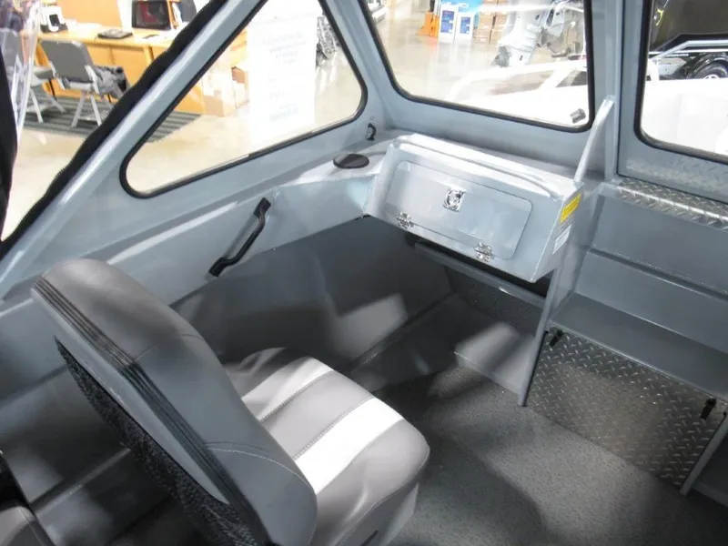 Slide: The Image of Interior of 2026 Hewescraft 180 Sportsman with seating and storage. - 13