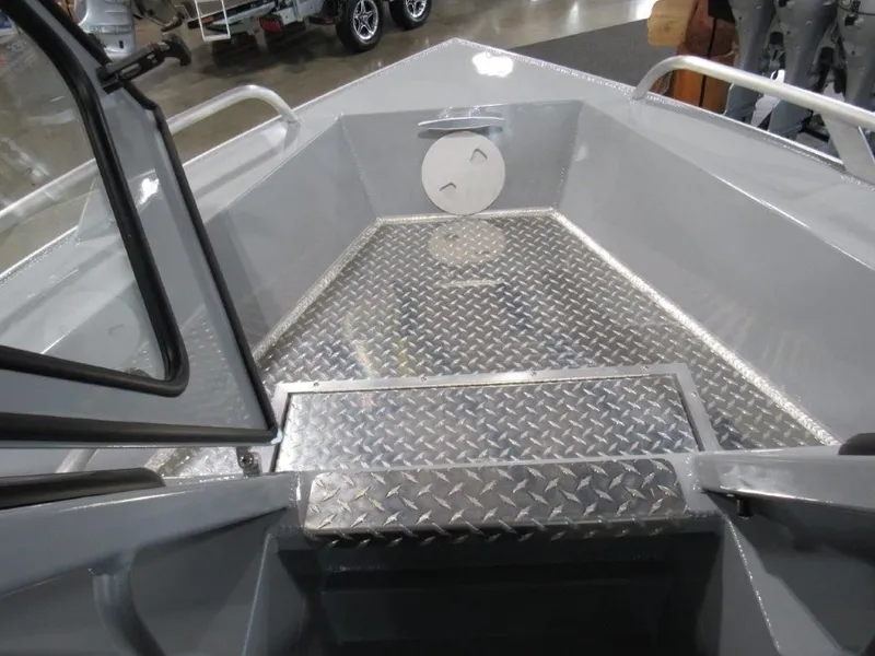 Slide: The Image of Interior view of 2026 Hewescraft 180 Sportsman boat with aluminum deck. - 16