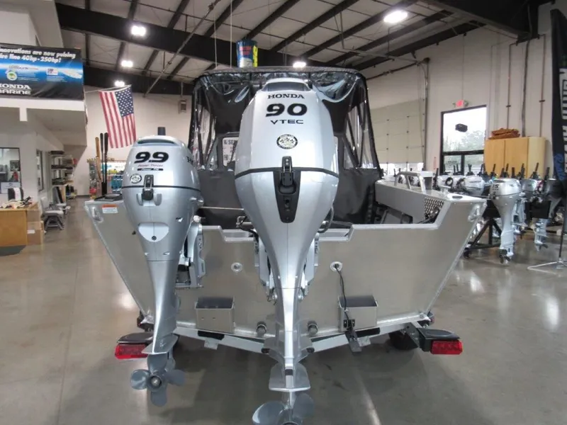 Slide: The Image of 2026 Hewescraft 180 Sportsman with Honda outboard motors in showroom. - 4