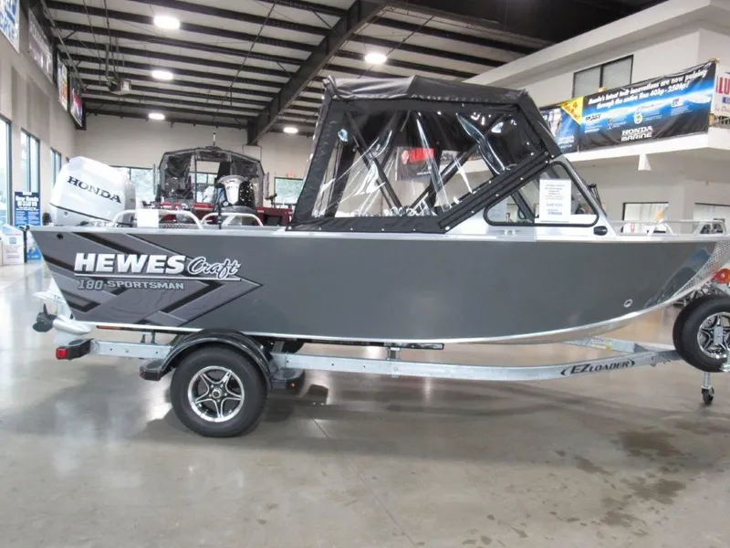 Slide: The Image of 2026 Hewescraft 180 Sportsman boat in showroom. - 6