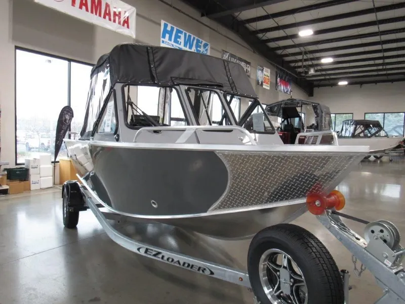 Slide: The Image of 2026 Hewescraft 180 Sportsman boat in showroom. - 7