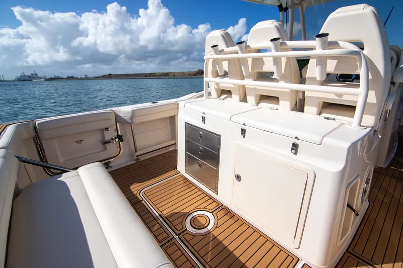 Slide: The Image of 2023 Grady-White Canyon 326 boat interior with seating and storage, on a sunny day. - 10