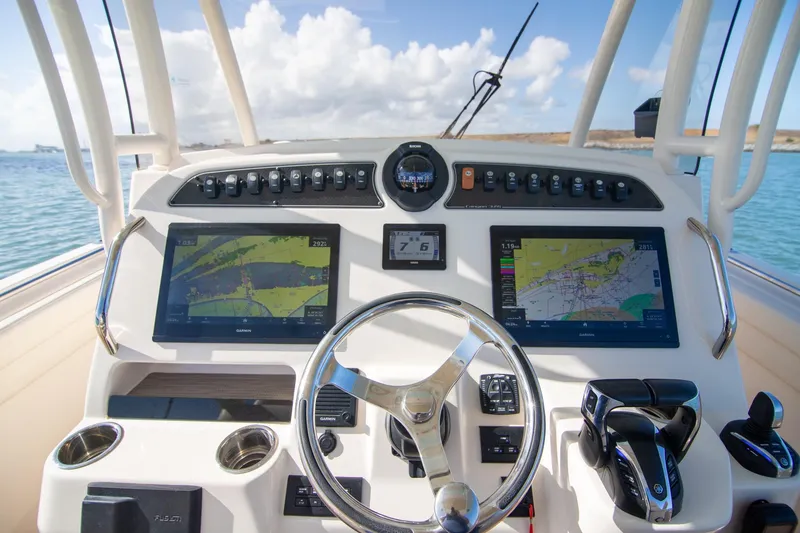 Slide: The Image of 2023 Grady-White Canyon 326 helm with dual navigation screens and steering wheel. - 13