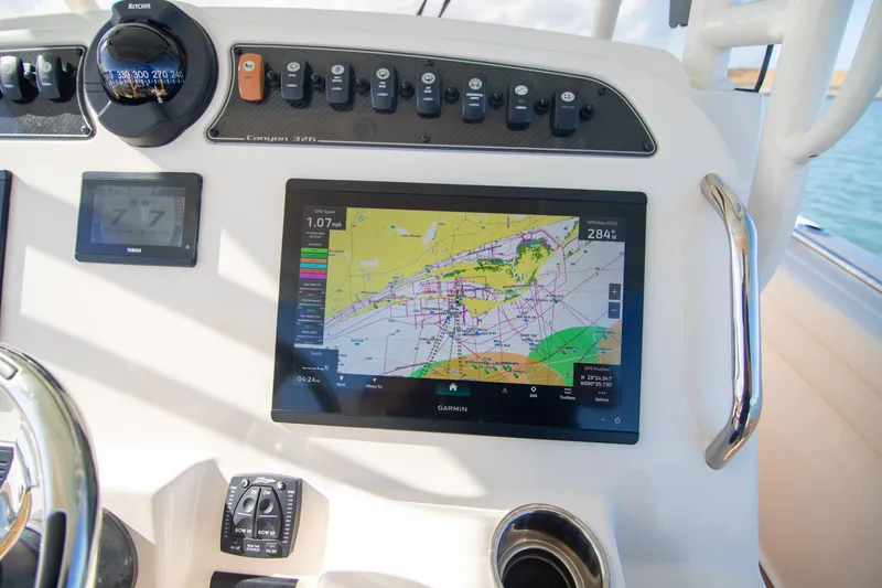 Slide: The Image of 2023 Grady-White Canyon 326 dashboard with navigation display and controls. - 16