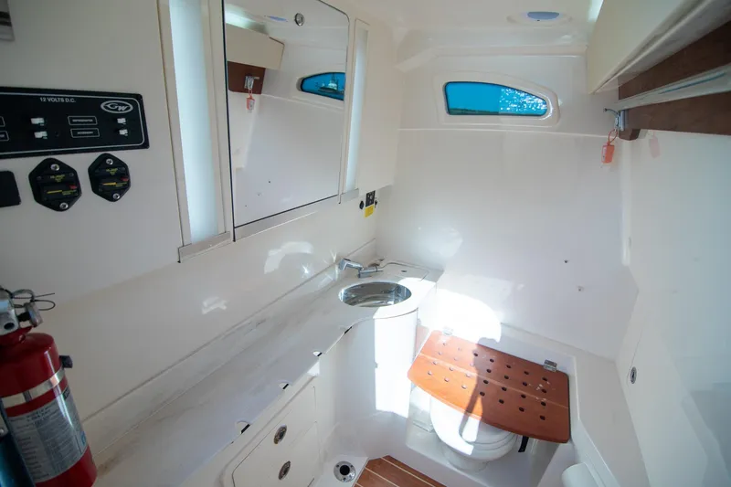 Slide: The Image of 2023 Grady-White Canyon 326 boat interior with sink, toilet, and control panel. - 21